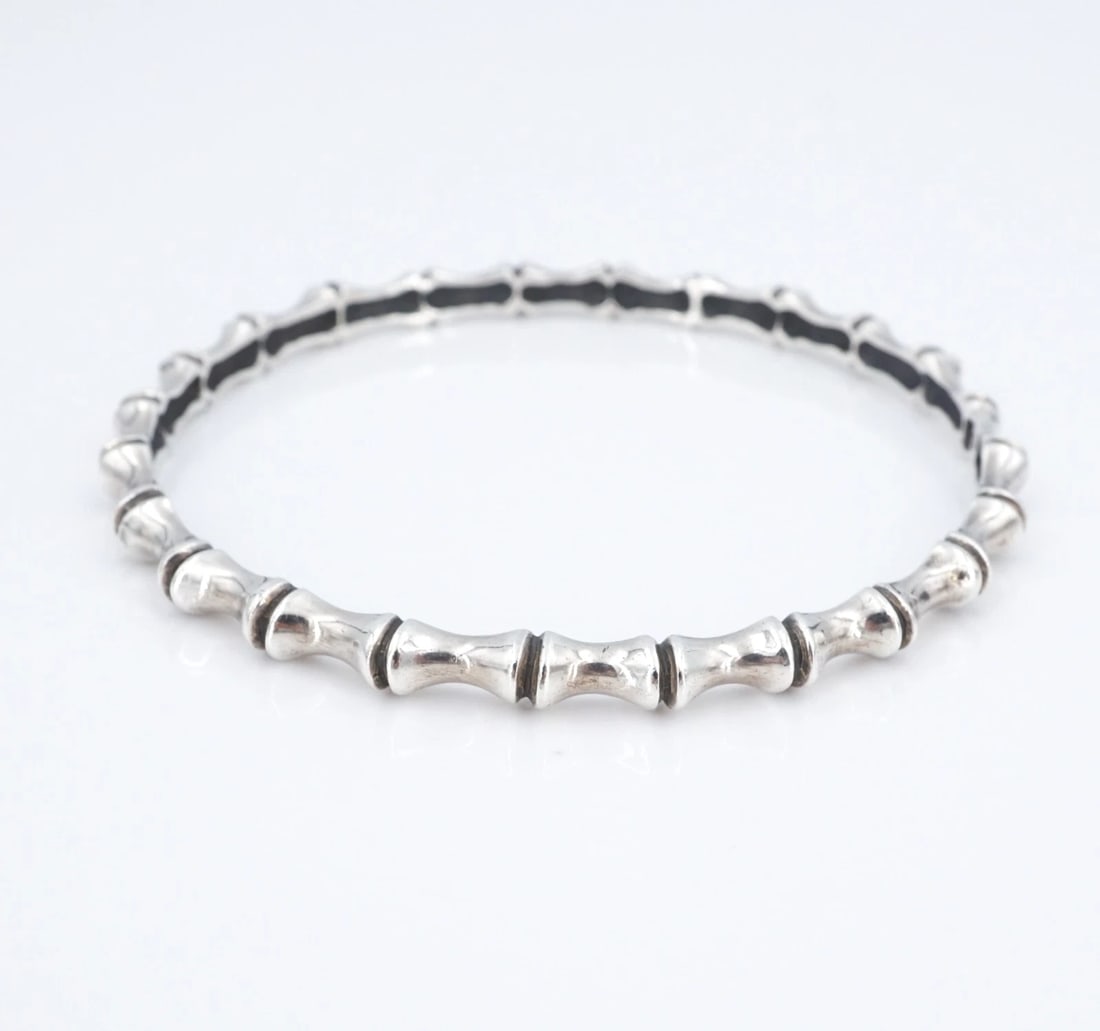 James Avery Bamboo Bangle Bracelet Sterling Silver 4.6mm 8" Retired BS3244: This retired James Avery bangle bracelet features a continuous bamboo branch motif crafted in solid sterling silver. Metal Type: Sterling Silver Notable Marks: JA Hallmark STER Measurements: 8" inner 