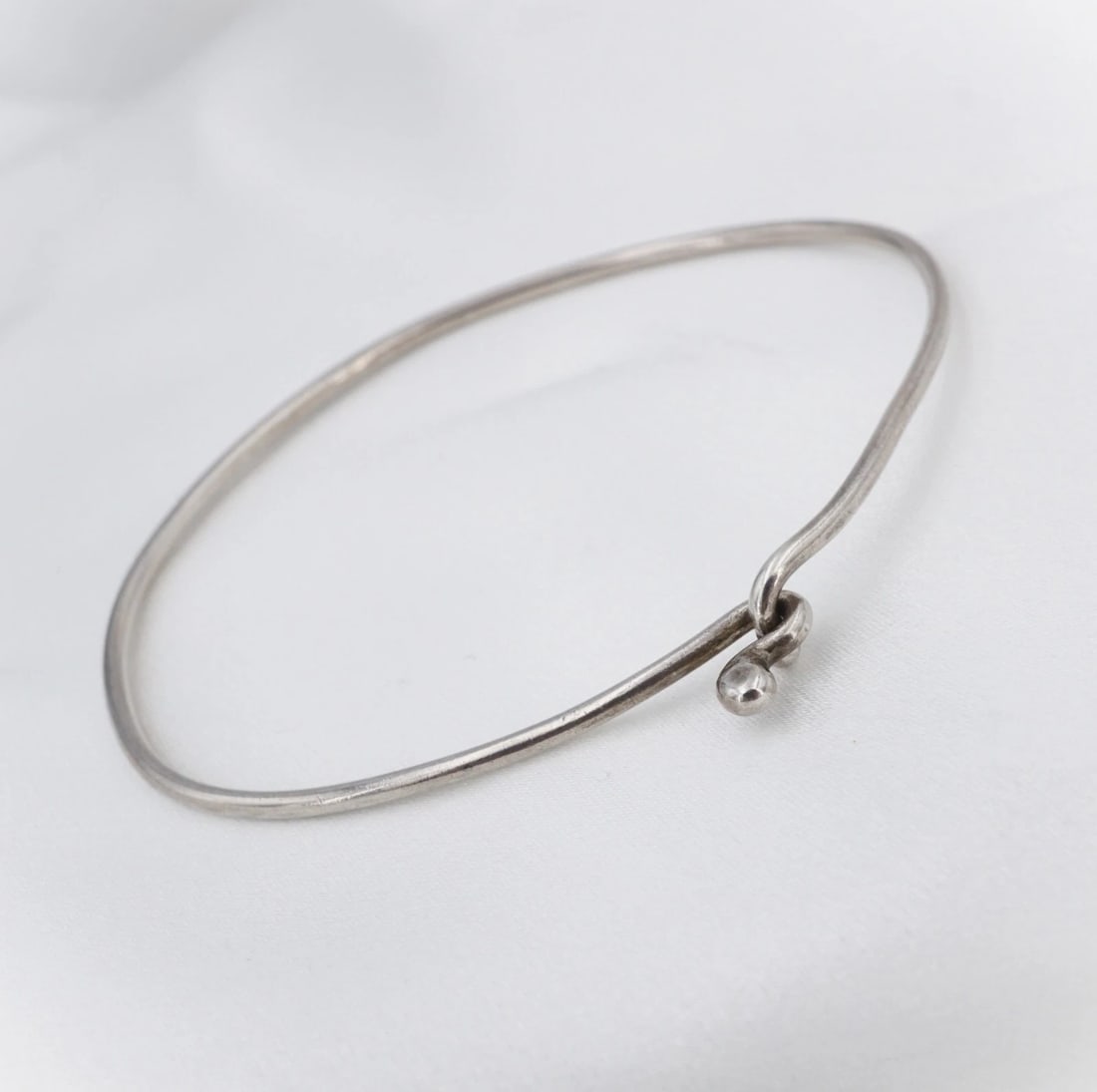 James Avery Hammered Hook-On Bracelet Sterling Silver 2 1/4" Stacker BS3360: This classic James Avery bracelet features a slim hammered bangle bracelet crafted in solid sterling silver with a sturdy hook-on closure. Described by Avery as "Designed with a hand-hammered finish, 