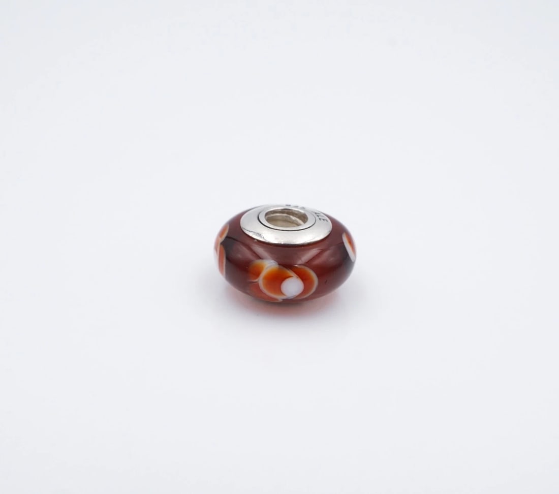 Pandora Murano Glass Flower Spacer Charm Red Sterling Silver 0.34" ALE CHS2327A: This classic spacer charm from Pandora features an opaque red Murano glass bead adorned with white flower motifs. Metal Type: Sterling Silver Notable Marks: Pandora 925 ALE Measurements: 0.34" x 0.58"