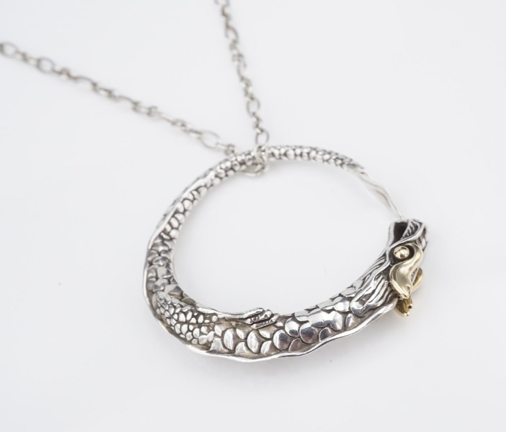 John Hardy Naga Legends Dragon Pendant Necklace Sterling Silver 18k Gold NS2304: This necklace from John Hardy features a circular pendant embellished with an ornate dragon motif with 18k yellow gold eyes. Suspended from an alternating link chain crafted in solid sterling silver, 