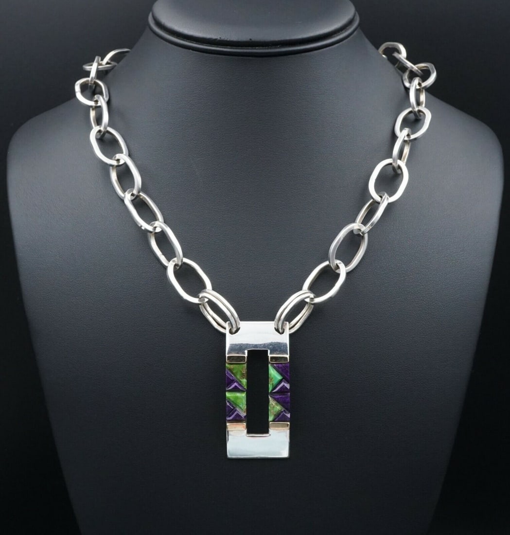 Valentin A Sterling Silver Inlay Pendant Necklace Carico Turquoise 20" Z NS952: This chunky statement necklace features an open squared modernist pendant inlaid with lime green Carico Lake turquoise and deep purple sugilite. The stones are precisely cut into triangular shapes to 