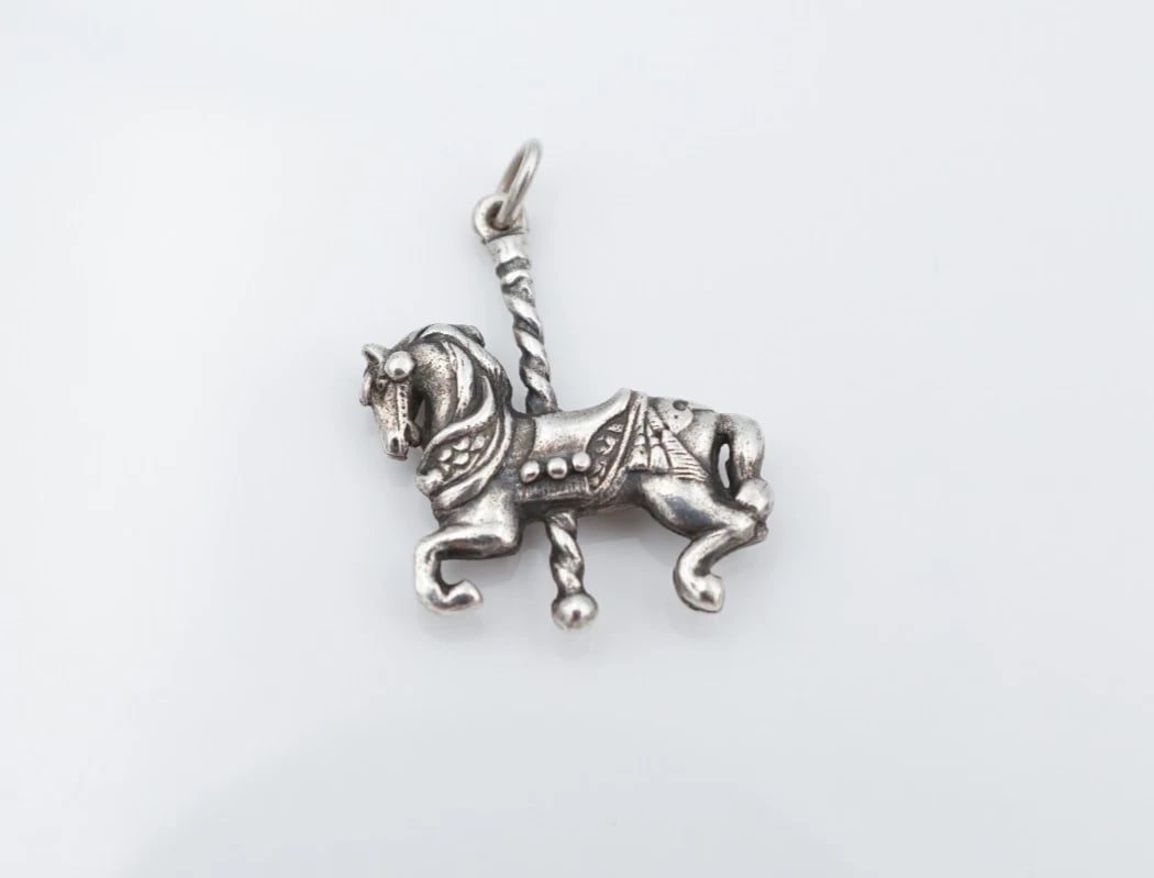James Avery Carousel Horse Charm Pendant 3D Sterling Silver 1" Retired CHS2310: This retired charm features an intricate 3D carousel horse design crafted in solid sterling silver. Metal Type: Sterling Silver Notable Marks: Avery STER Measurements: 1" x 0.85" hang; 4.9 grams Condi
