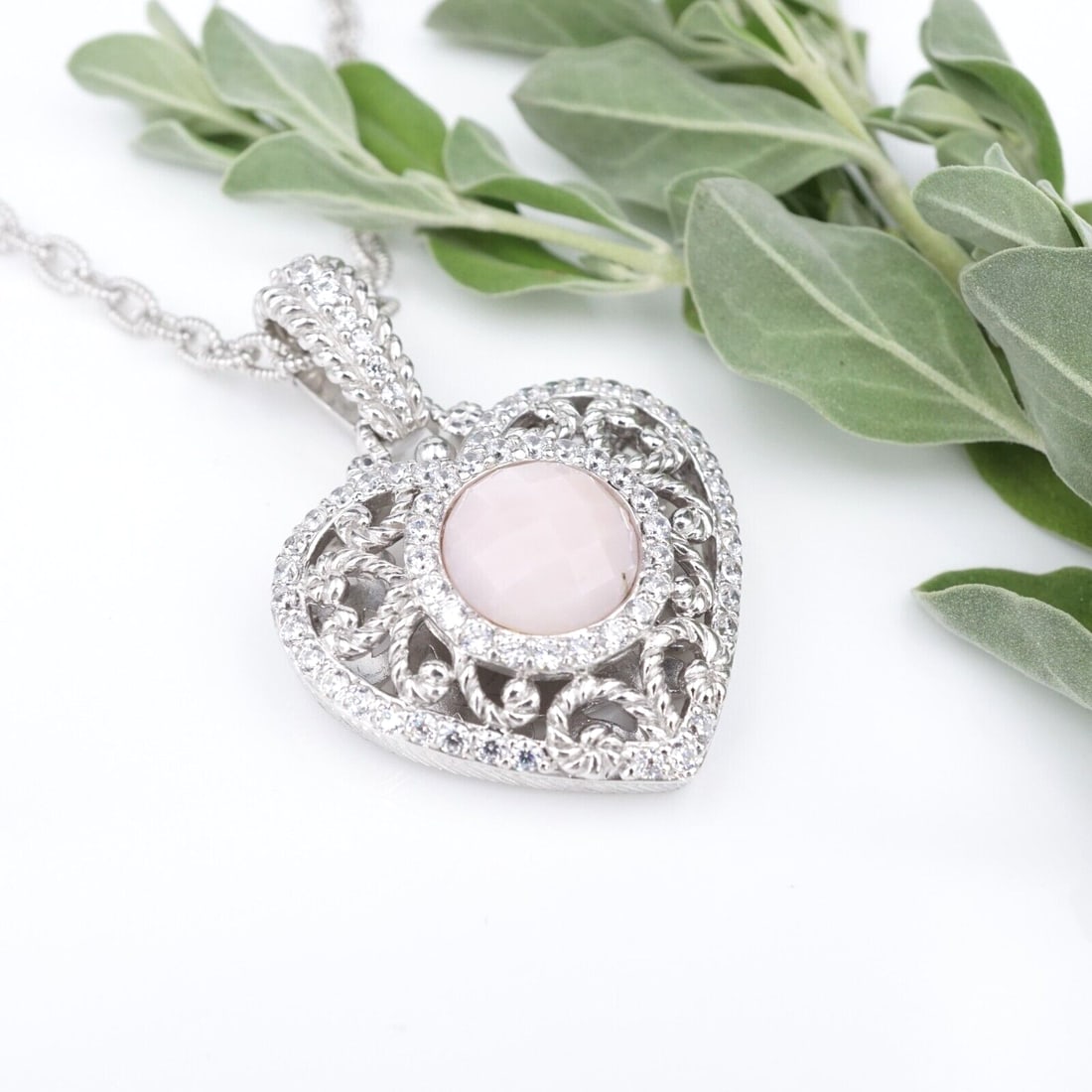 Judith Ripka Sterling Silver Pink Opal Heart Necklace Enhancer Pendant NS2075: This modern necklace features six heart stations accented with sparkling cubic zirconia. A heart enhancer pendant hangs below with a pink opal center with cubic zirconia halo and border. All crafted f