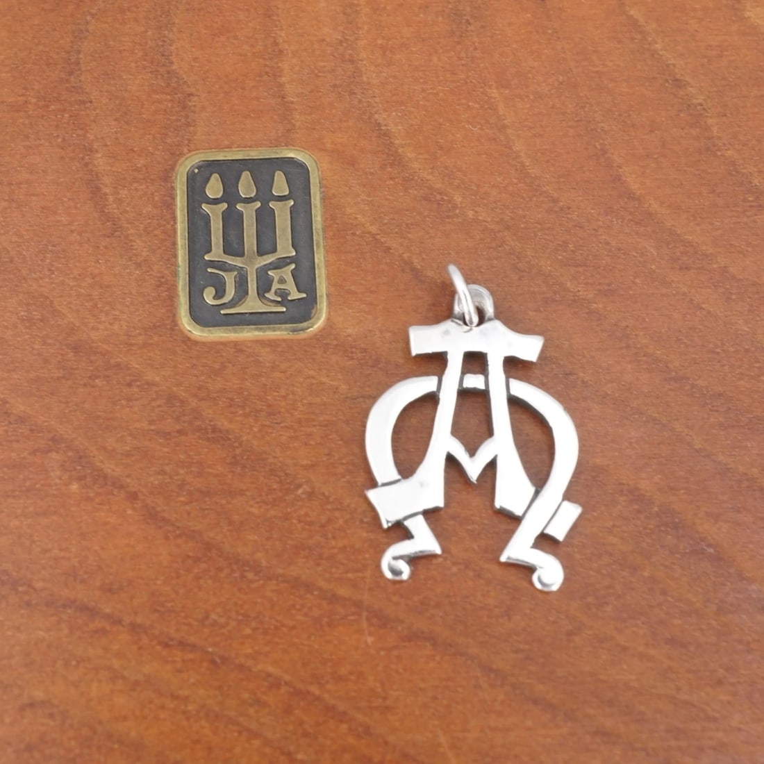 James Avery Alpha Omega Pendant Sterling Silver 1" Retired PS2287: This retired James Avery pendant features a 3D ichthus fish pendant with a raised cross design in the center. The back of the pendant is engraved with the letters "IHS" representing the first three le