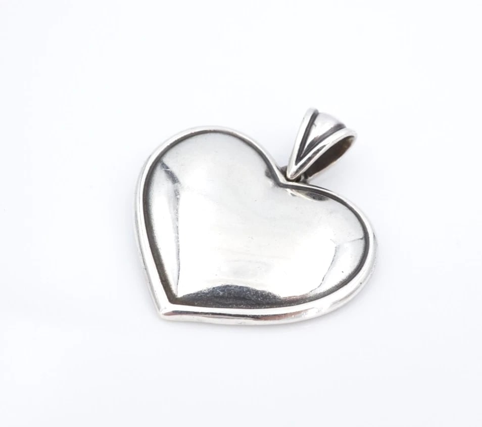 James Avery Bubble Heart Pendant Wide Sterling Silver 1.4" Retired Rare PS2361: This retired James Avery pendant features a large, domed heart pendant crafted in solid sterling silver. Metal Type: Sterling Silver Notable Marks: JA Hallmark 925 Measurements: 1.5" x 1.2"; 11.5 gram