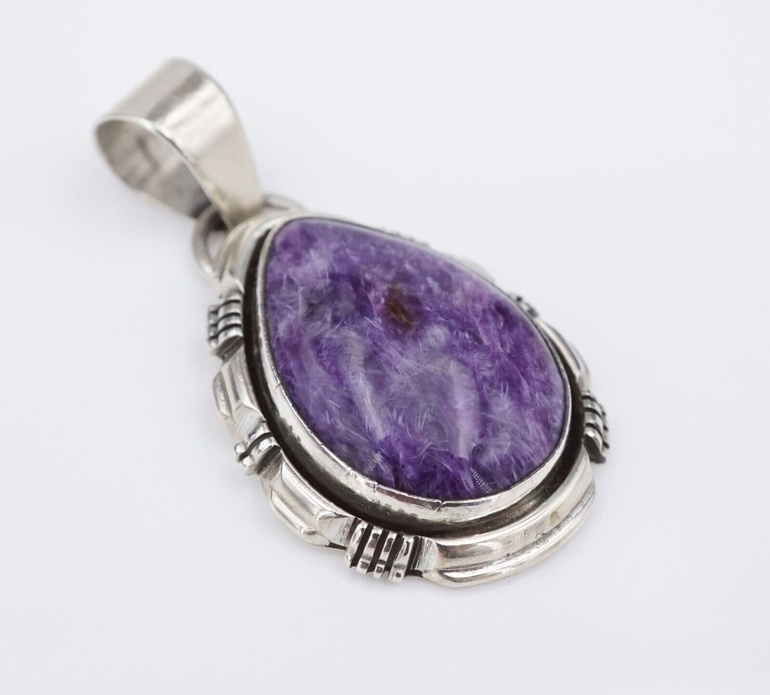 Navajo L Yazzie Sterling Silver Purple Sugilite Pendant Cabochon 1.8" PS2097: This Navajo pendant, from the illustrious Yazzie family, features a teardrop purple sugilite cabochon set in a scalloped frame. The large tapered bale gives this piece a bold look and provides great m