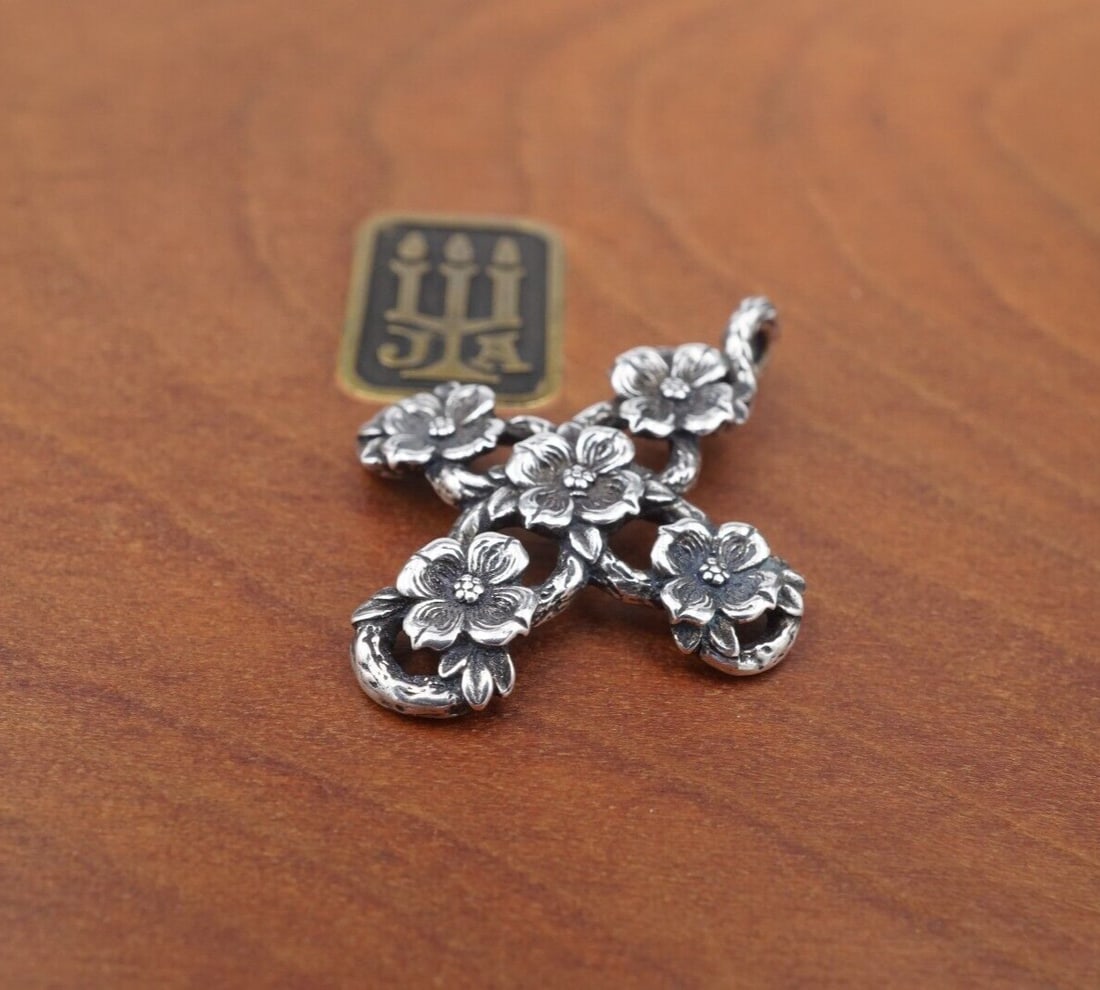 James Avery Dogwood Cross Pendant Sterling Silver Retired 1.25" Flower PS2209: This retired James Avery cross pendant features an ornate open work frame with dogwood flower designs crafted in solid sterling silver. Metal Type: Sterling Silver Notable Marks: Avery Hallmark Ster M