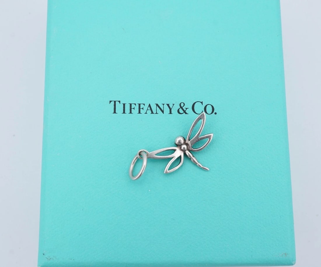 Tiffany & Co Dragonfly Insect Charm Pendant Sterling Silver 1.2" Retired CHS2359: This retired Tiffany & Co. charm features a 3D dragonfly design crafted in solid sterling silver with openwork wings. Metal Type: Sterling Silver Notable Marks: T & Co. 925 Measurements: 1.2" x 0.96";