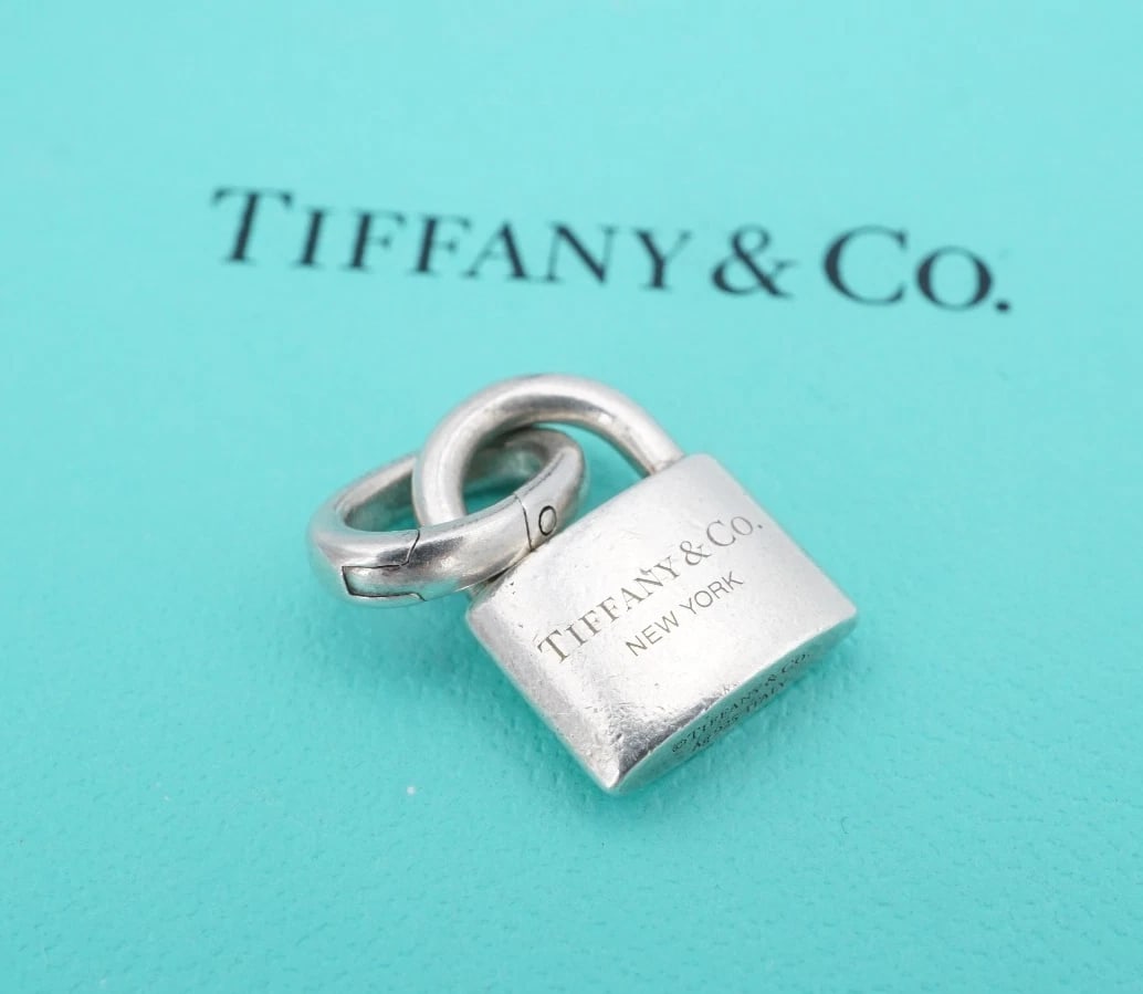 Tiffany & Co Lock Clip Bale Charm Sterling Silver Hardwear Padlock CHS2361: This classic Tiffany & Co. charm features a padlock charm from the Hardwear Collection. With clip bale for attaching to the necklace or bracelet of your choice. Metal Type: Sterling Silver (tested and