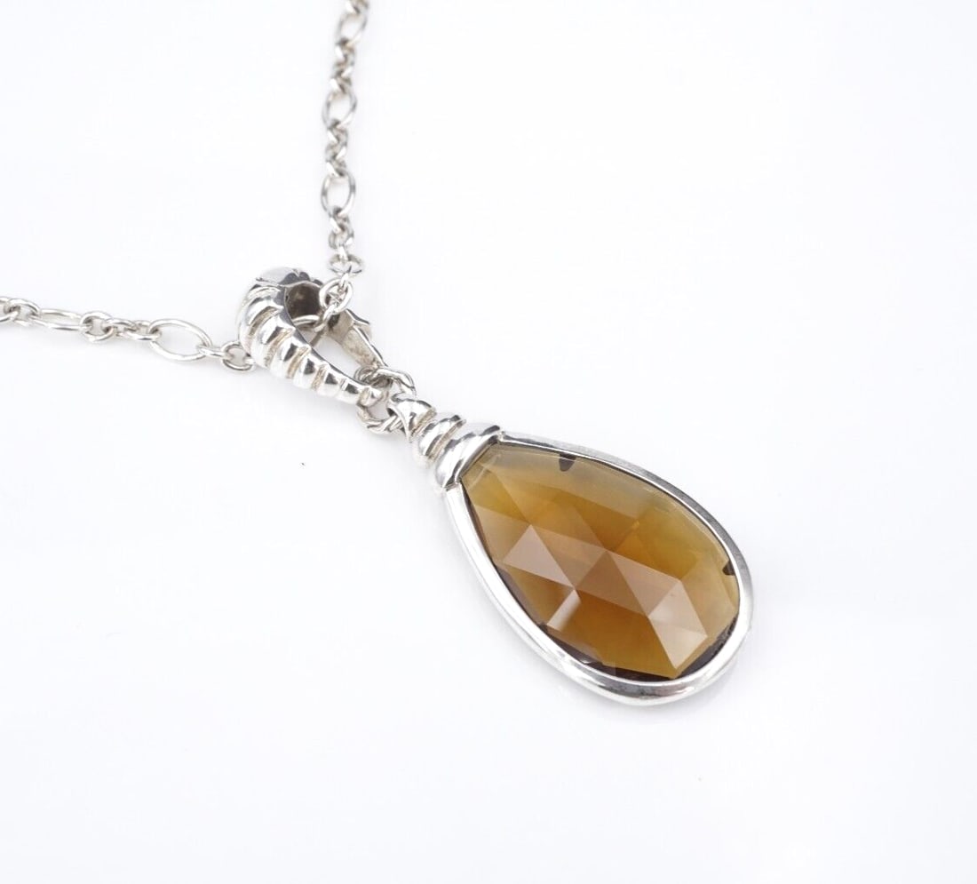 John Hardy Sterling Silver Smoky Quartz Necklace 3.8mm Enhancer 20" Bezel NS2232: This necklace from designer John Hardy features a pear cut smoky quartz gemstone bezel set in a sterling silver frame paired with a fluted enhancer bale. The pendant hangs gracefully from a delicate c