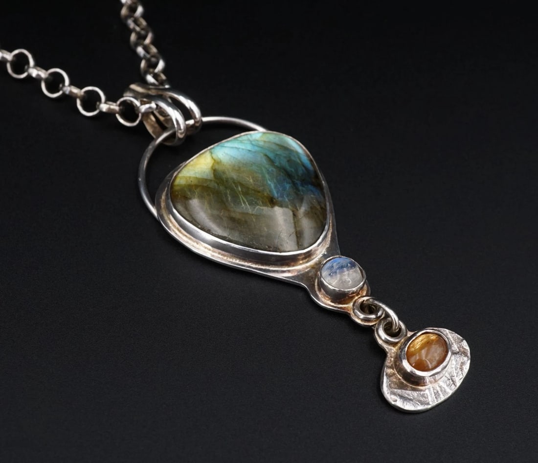 Designer Stone Blossoms Labradorite Moonstone Sterling Silver Necklace NS2456: This necklace from design house Stoneblossoms Jewelry features a large labradorite bezel set atop a tapered sterling silver pendant suspended from a chunky cable chain with a sturdy spring ring clasp.