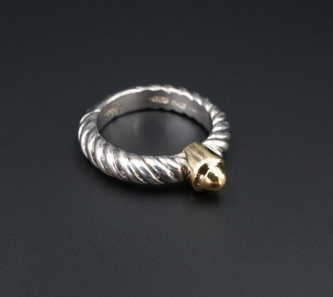 Jonah Grossbardt Sterling Silver 18k Gold Bullet Cable Band Ring Sz 6.25 RS3148: This sleek Jonah Grossbardt ring features a solid sterling silver construction with a cable design. A 18k yellow gold "bullet" accents the center face of the ring. Metal Type: Sterling Silver and 18k 