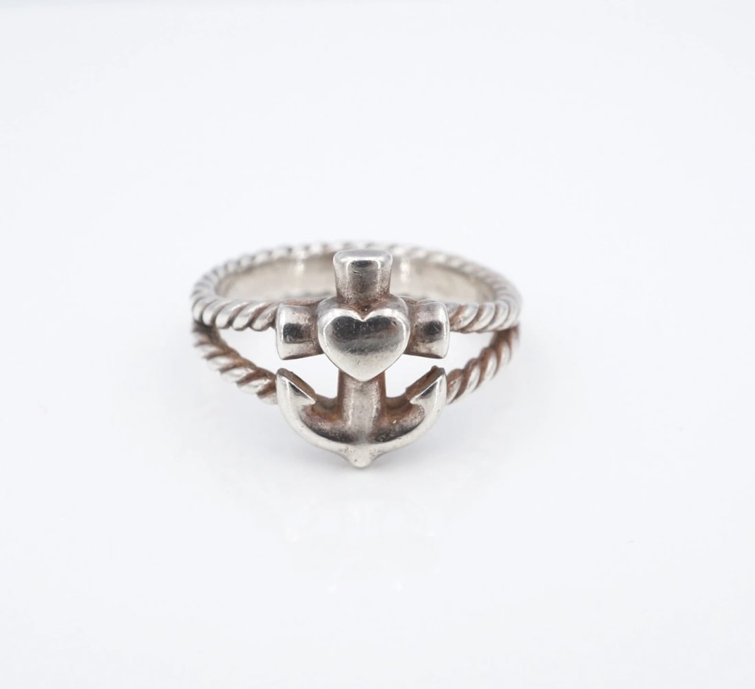 James Avery Faith Hope Love Ring 7/16" Sterling Silver Size 7.75 Retired RS4022: This classic James Avery Faith, Hope, and Love ring features a cross anchor with a heart at the center, set atop a split shank sterling silver band with a rope texture. Metal Type: Sterling Silver Not
