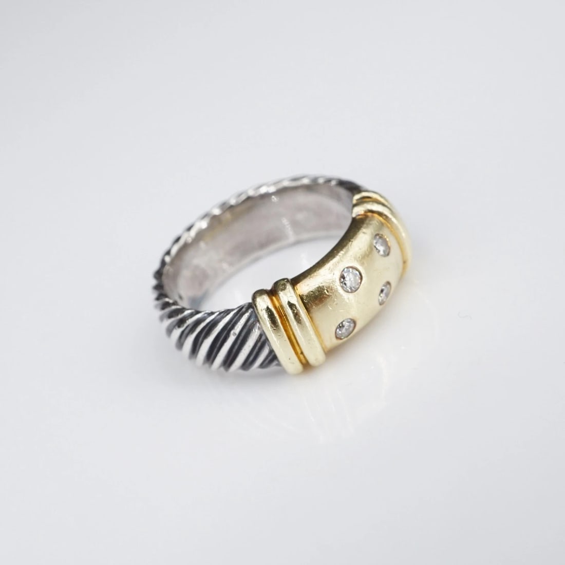 David Yurman Metro Ring 4 Diamond Sterling Silver 14k Gold Size 5.5 RS3941: This retired David Yurman Metro ring features natural round diamonds flush mounted in a bar of 14k yellow gold atop a sterling silver band with a wide cable-style shank. Metal Type: Sterling Silver No