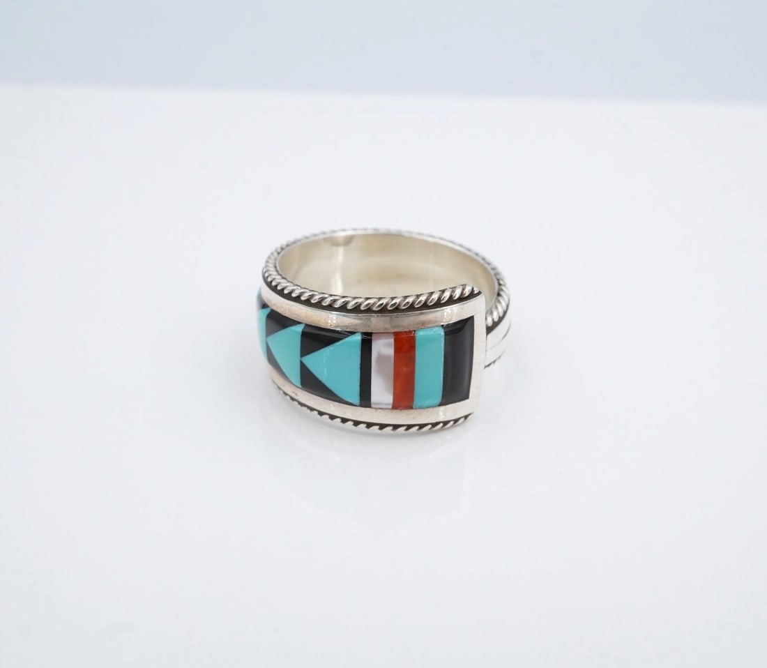 Zuni Multi-Stone Inlay Band Ring Sterling Silver Size 11 Bernard Cachini RS4044: This ring from Zuni artisan Bernard Cachini features a geometric inlay of turquoise, red coral, mother of pearl, and onyx set flush in a solid sterling silver band with a tapered design. Metal Type: S