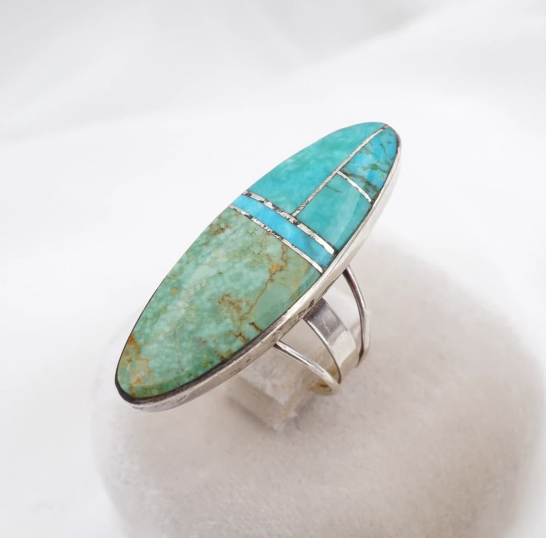 Zuni Turquoise Inlay Cocktail Ring Sterling Silver Size 9.25 Harold Smith RS4061: This statement ring from Zuni artisan Harold Smith features a geometric, turquoise inlay bezel-set in a solid sterling silver mount with a split shank design. Metal Type: Sterling Silver Notable Marks