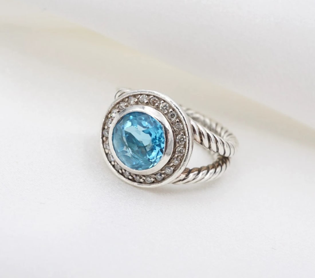 David Yurman Topaz Diamond Cerise Cocktail Ring Sterling Silver Size 4 RS4091: This retired David Yurman Cerise ring features a checkerboard round blue topaz gemstone framed by a bright white diamond halo and set atop a solid sterling silver mount with a cable style split-shank.