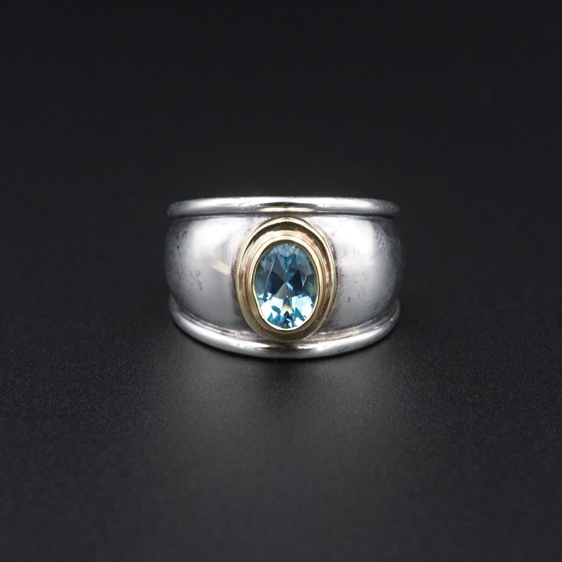 James Avery Christina Topaz Ring Sterling Silver 18k Gold Sz 6.25 Retired RS3707: This "Christina" ring from James Avery features a vivid blue, oval cut topaz bezel set in 18k yellow gold atop wide solid sterling silver band. The gently domed center accentuates the elegant design. 