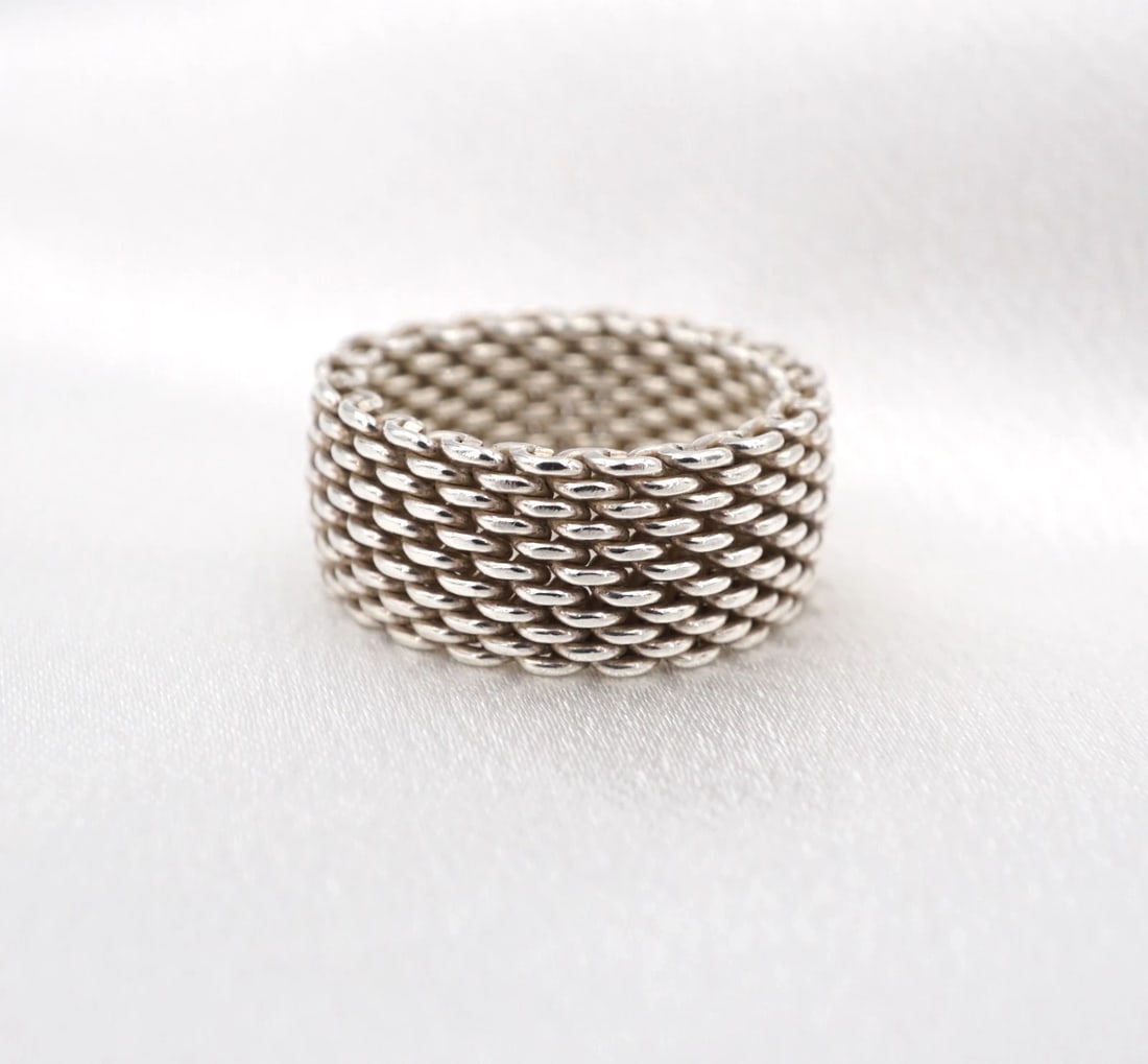 Tiffany & Co. Somerset Band Ring 10mm Sterling Silver Size 7.5 Retired RS3956: This Tiffany & Co. "Somerset" ring features sterling silver mesh construction. Metal Type: Sterling Silver Notable Marks: T&Co 925 Measurements: Size: 7.5; Band: 10 mm Weight: 9.1 grams Condition: Ver