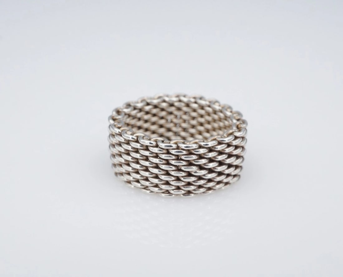 Tiffany & Co. Somerset Band Ring 10mm Sterling Silver Size 7.25 Retired RS3845: This Tiffany & Co. "Somerset" ring features sterling silver mesh construction. Metal Type: Sterling Silver Notable Marks: Tiffany & Co 925 Measurements: Size: 7.25; Band: 10 mm Weight: 8.7 grams Condi