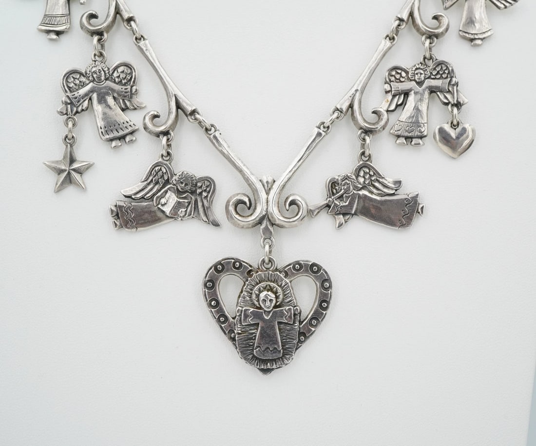 Jeep Collins Sterling Silver Necklace Angel Heart Dangle Statement 22" NS2470: This piece from designer Jeep Collins features a solid sterling silver necklace with an intricate design. Centered on a large heart pendant, with six guardian angel stations along the dogbone links. M