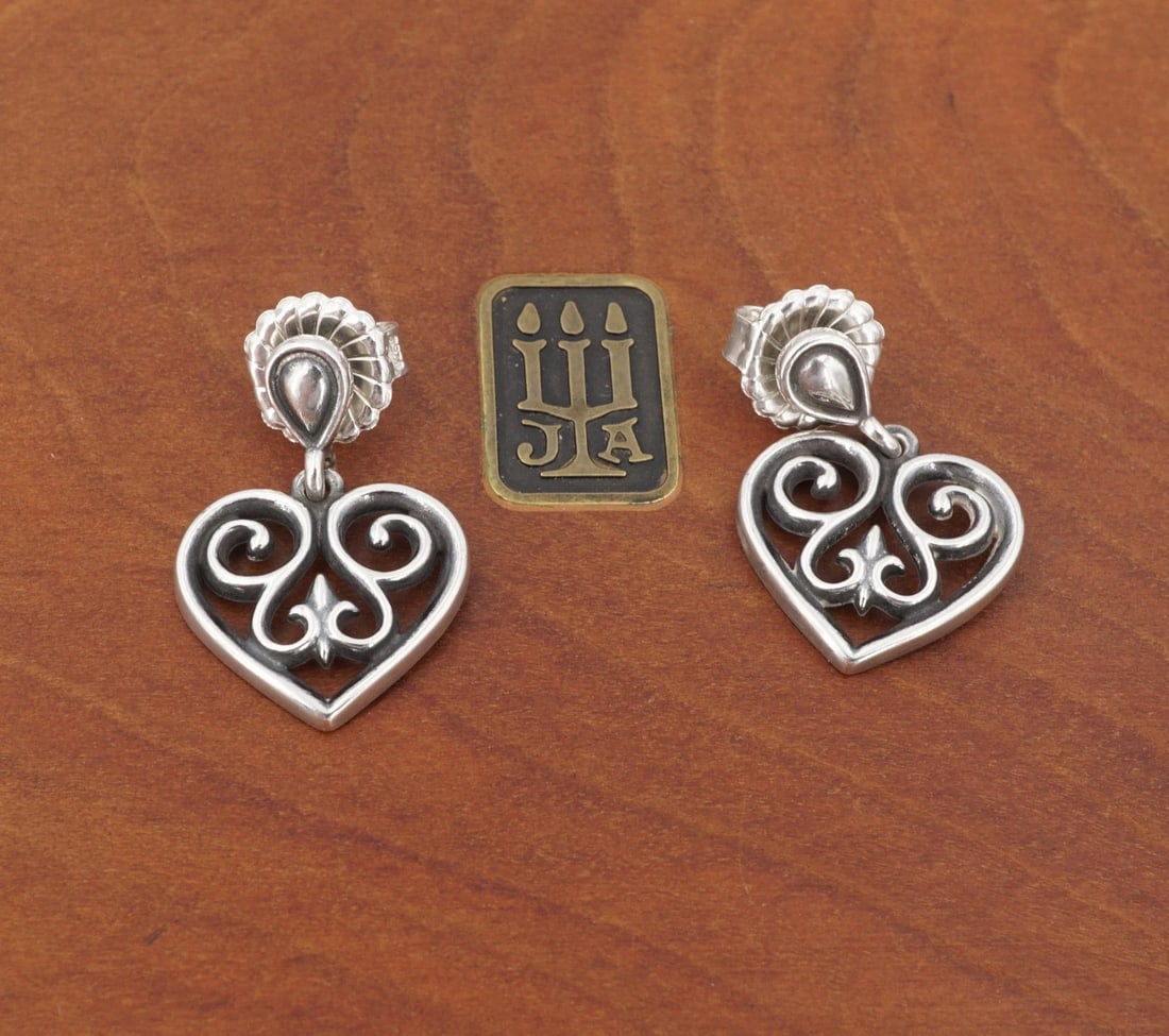 James Avery French Scroll Heart Drop Earrings Sterling Silver 1" Retired ES2781: This retired pair of sterling silver earrings from James Avery feature an openwork heart design embellished with ornate scroll accents. Suspended from a teardrop shaped stud, these earrings are a fun 