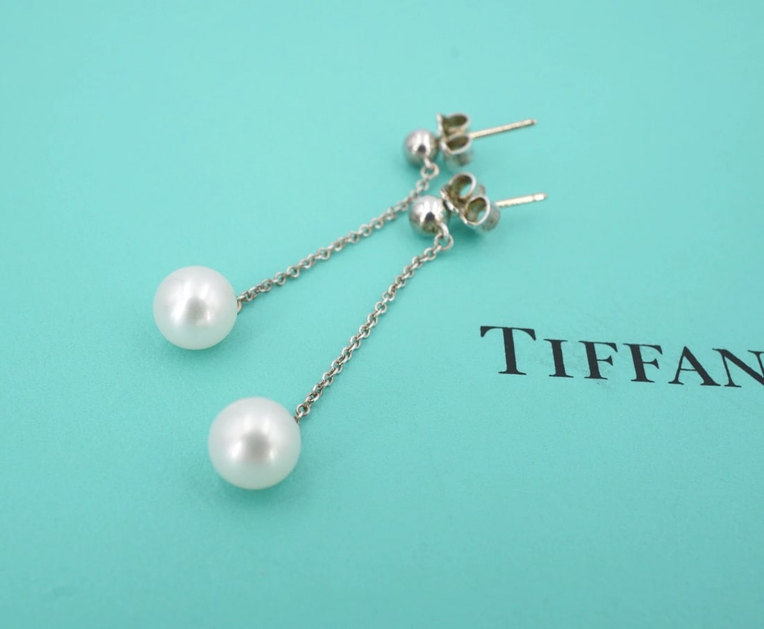 Tiffany & Co. Pearl Drop Earrings Ziegfeld Sterling Silver 1.6" Retired ES2856: These retired Tiffany & Co. earrings from the Ziegfeld Collection feature a sterling silver ball stud with a large freshwater pearl accent dangling beneath. Described by Tiffany as "Inspired by Tiffan