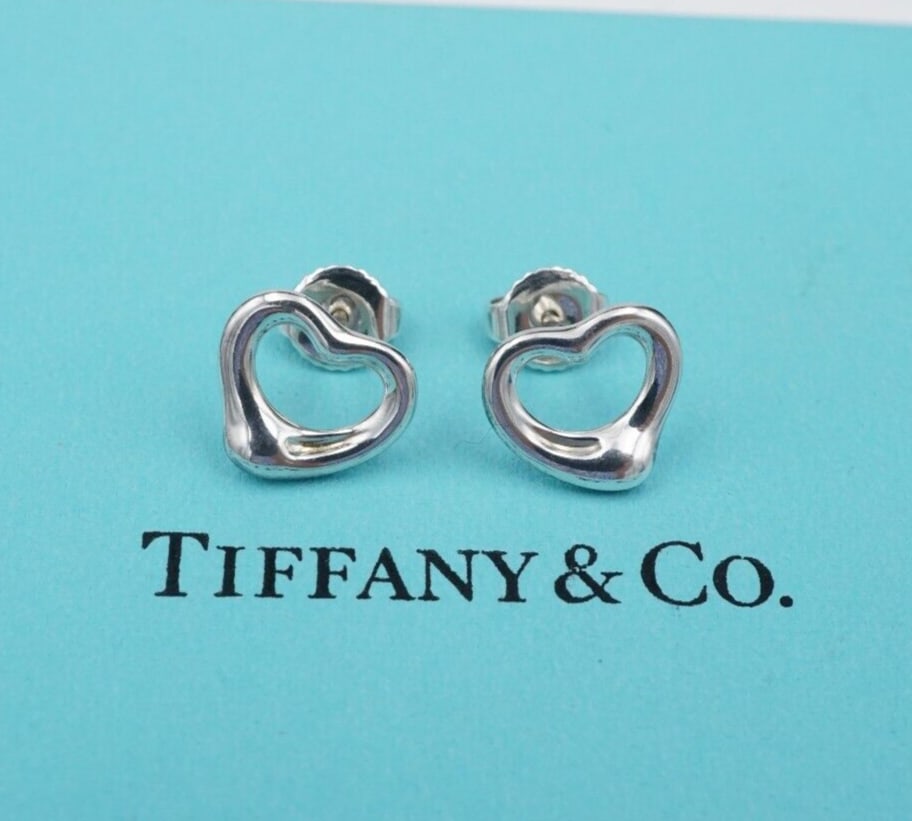 Tiffany & Co. Elsa Peretti Open Heart Stud Earrings Sterling Silver 11mm ES2638: These Tiffany & Co. earrings from designer Elsa Peretti feature an asymmetrical open heart stud design crafted in sterling silver. Metal Type: Sterling Silver Notable Marks: Tiffany & Co. Elsa Peretti