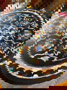 Pietra Dura Stone Inlaid Table: This Pietra Dura stone inlaid table is a stunning masterpiece of craftsmanship and artistry. Featuring intricate, hand-laid stonework, the table’s surface showcases beautifully detailed designs usin