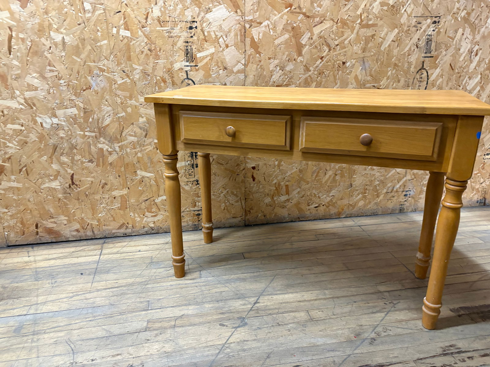 Country Pine Console Table with Turned Legs and Two Drawers: Charming country-style console table crafted from solid pine, featuring two drawers with round wooden knobs and turned spindle legs. The warm honey finish brings out the natural grain of the wood, add