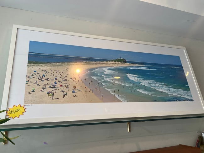 Doug Cliff Signed Panoramic Photograph Nobby's Beach, Summer: Transport yourself to the sunny shores of Australia with this breathtaking panoramic photograph titled Nobby's Beach, Summer” by acclaimed photographer Doug Cliff. Featuring an expansive aerial