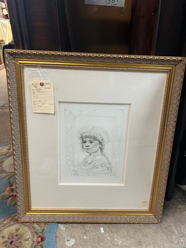 Framed Edna Hibel Lithograph Young Girl with Headdress, Signed in Plate: This delicately rendered lithograph by Edna Hibel features a young girl in profile, adorned with a soft, romantic headdress and surrounded by an ornate border. Known for her depictions of maternal