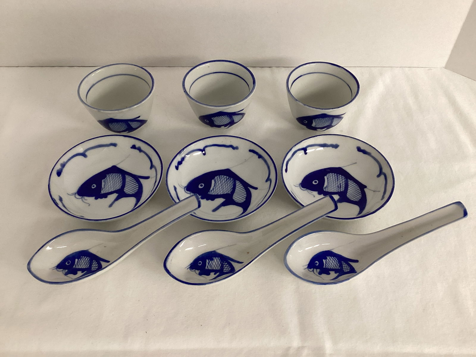 Three Blue and White Chinese Bowls, Spoons, and Cups with a Fish Pattern (1 of 9)