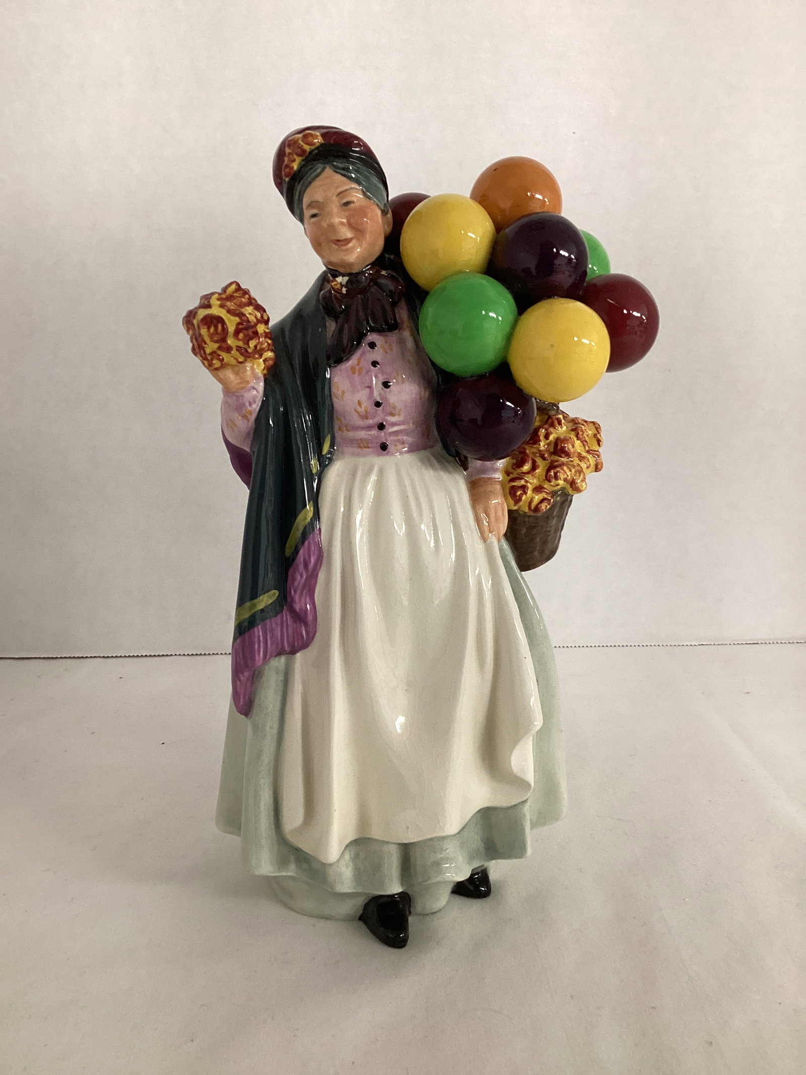 Royal Doulton "Biddy Pennyfarthing" Balloon and Flower Lady Vendor Figurine: HN1843, crazing, 9 1/4" h, bow repaired