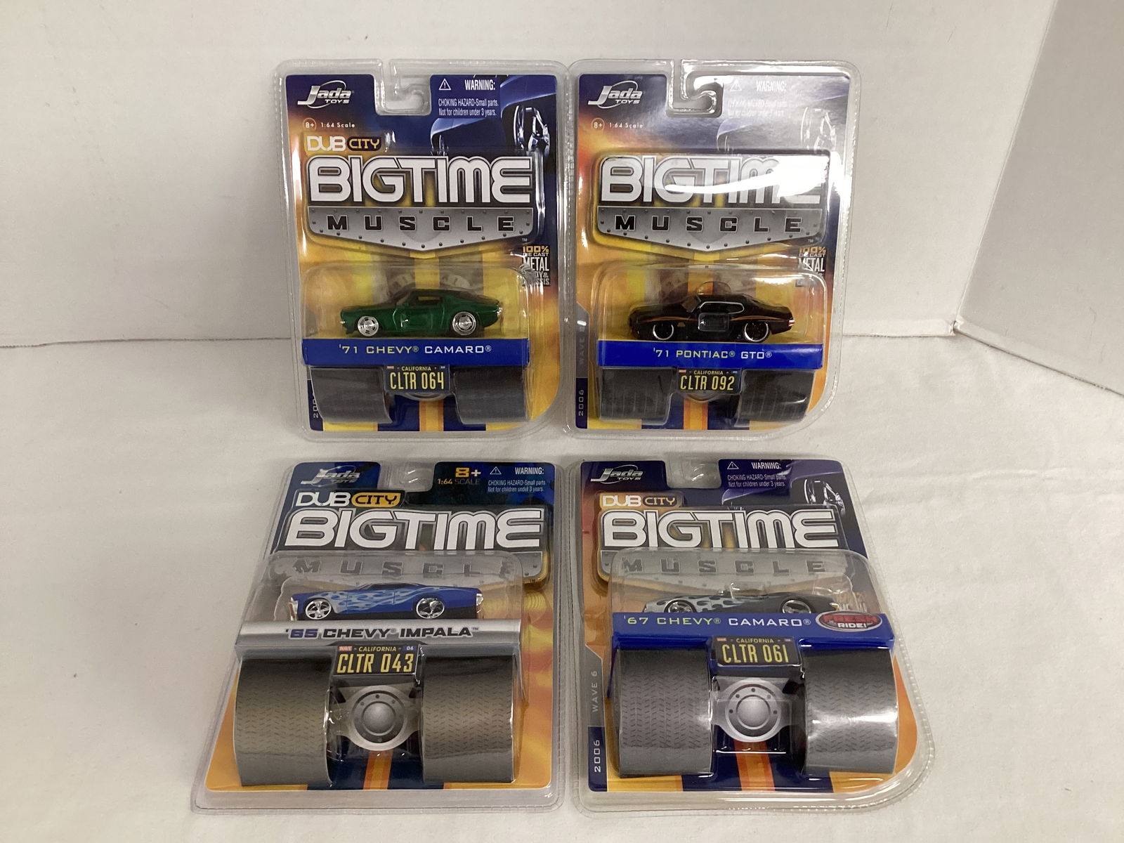 Four Jada Big Time Muscle Diecasts: 1967 Chevy Camaro, 1965 Chevy Impala, 1971 Chevy Camaro, and 1971 Pontiac GTO