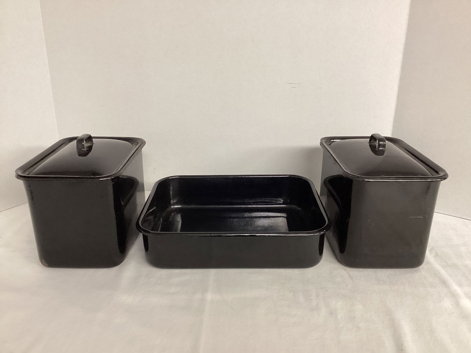 Black Enamel Refrigerator Boxes and Pan: One box has chips to enamel. 10 1/2" x 8 1/2" x 2 1/2" h pan, 7 1/2" x 5 1/2" x 5 1/2" h boxes