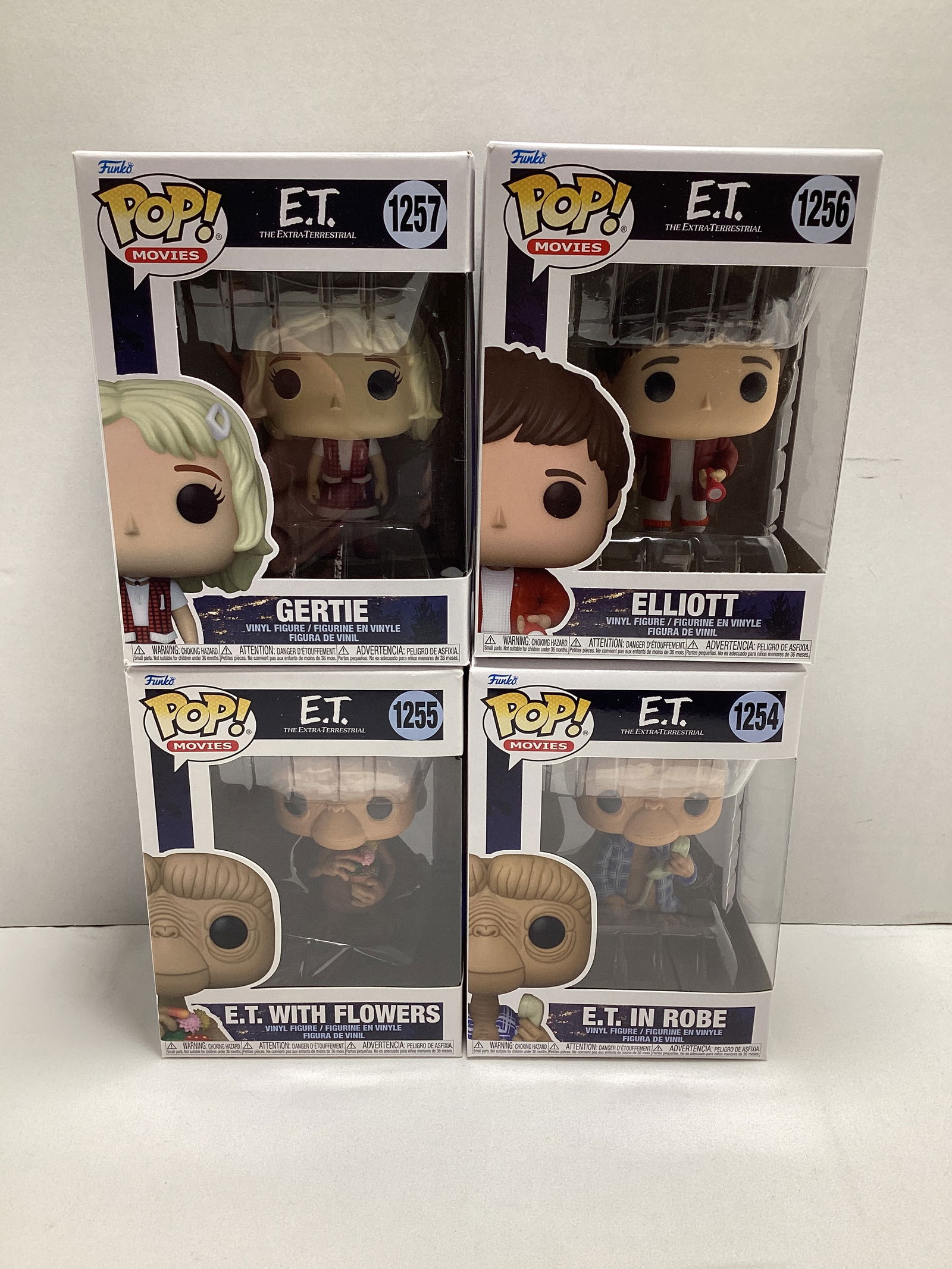 Four ET The Extra Terrestrial Funko Pops: Gertie, Elliott, ET with Flowers, ET in Robe