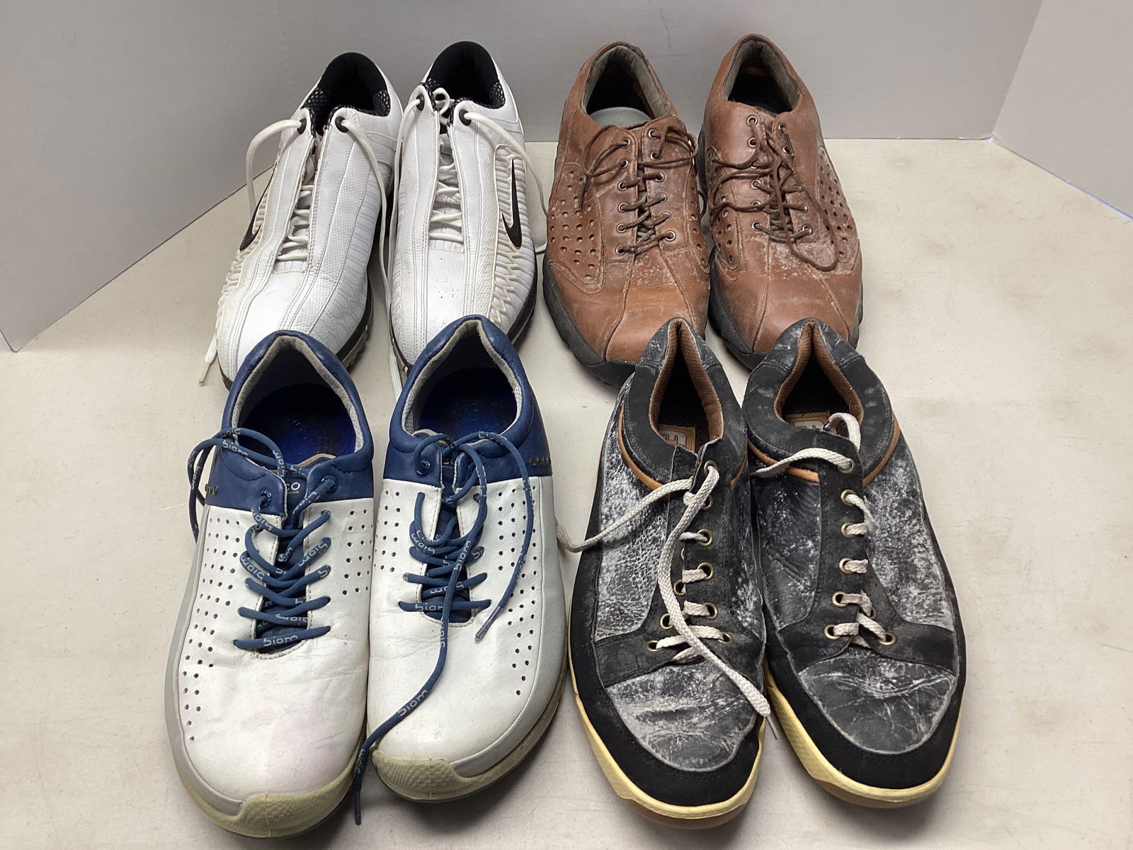 Four Pair of Men's Golf Shoes: need cleaning, Foot Joy 10, Ecco (no size), Nike 10W, Oakley 11 