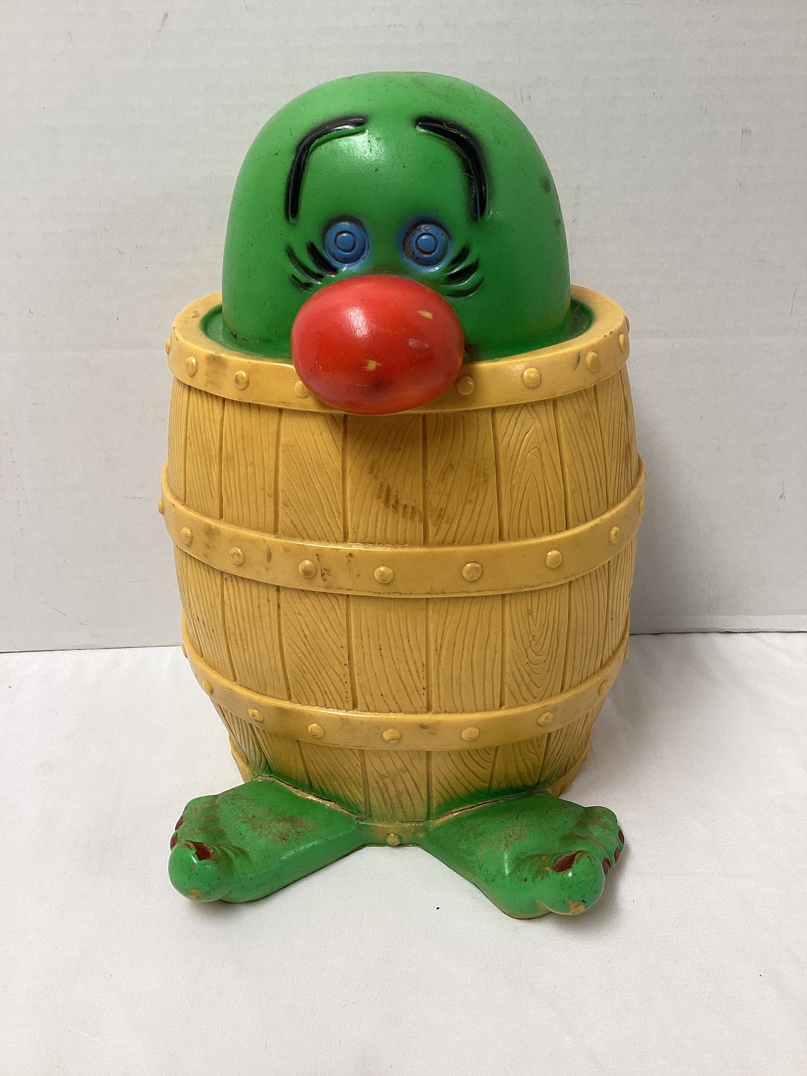 Green and Yellow Kilroy Peek-a-Boo Barrel Bank: cracking at feet, 12 1/2" h