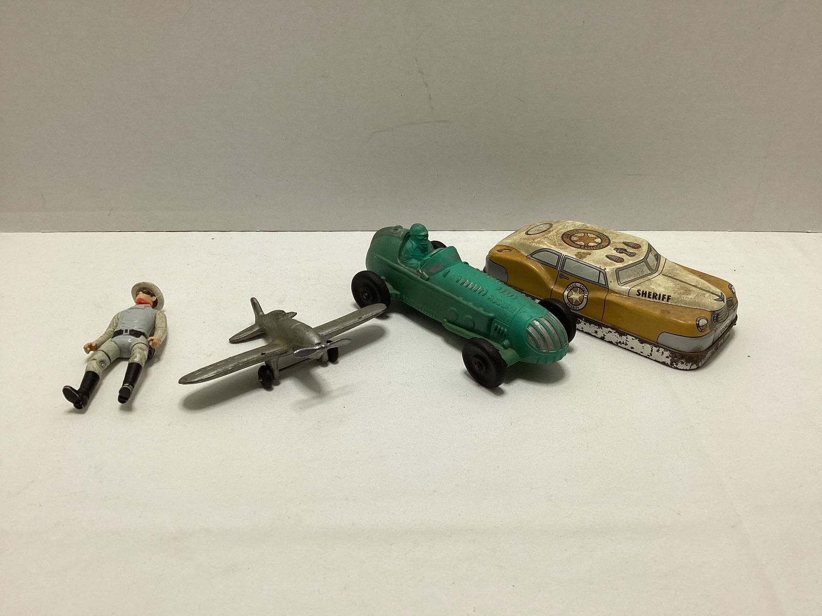 Auburn Rubber Racecar, Fossil Case, Lone Ranger Action Figure, and Auburn Airplane: .