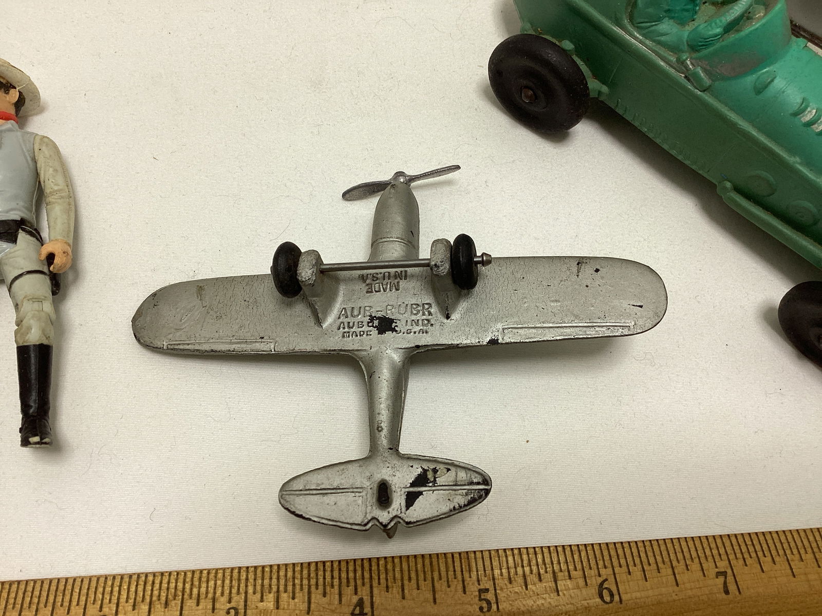 Auburn Rubber Racecar, Fossil Case, Lone Ranger Action Figure, and Auburn Airplane - 3