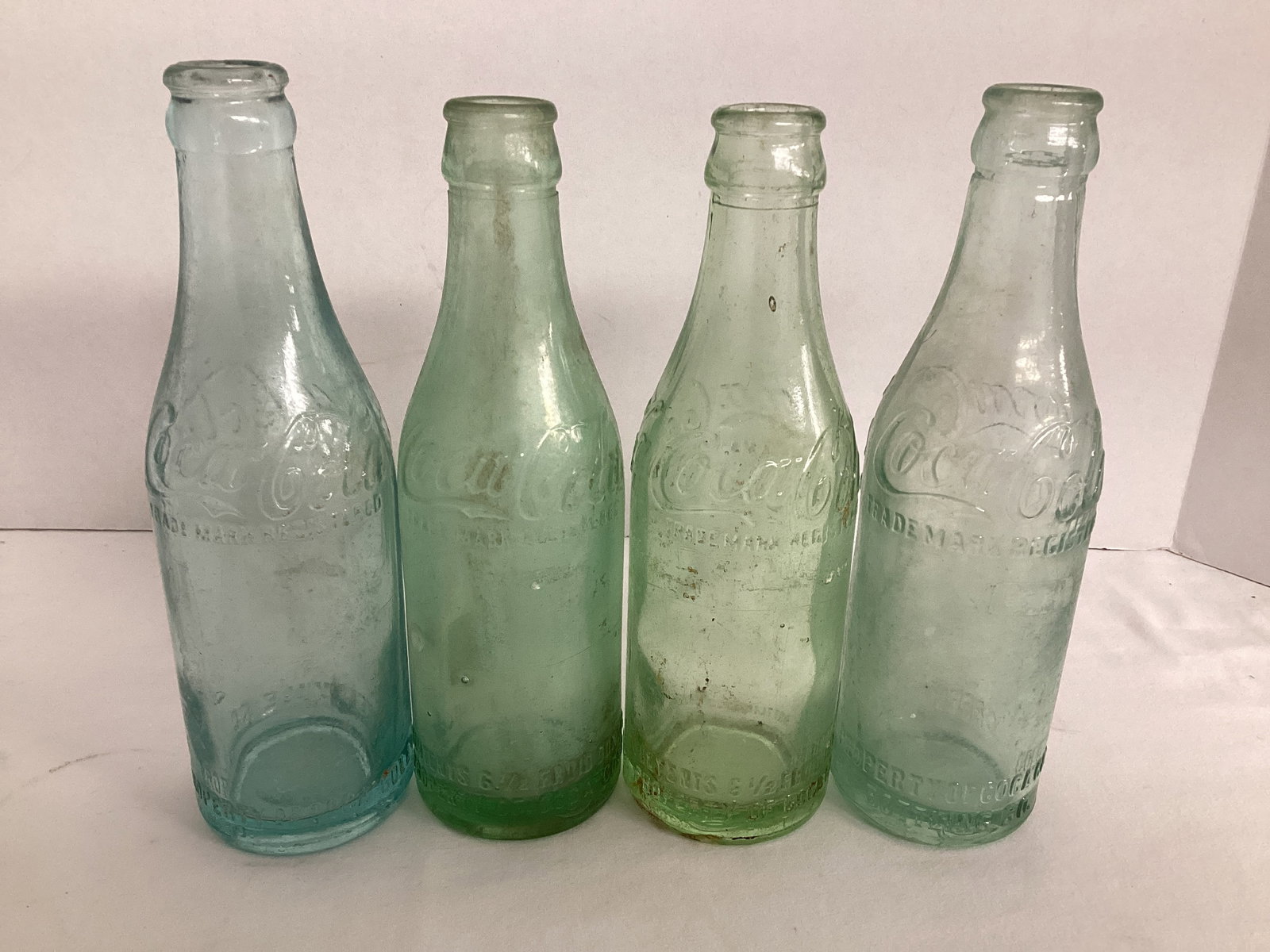 Green Glass Straight Coca-Cola Bottles Bottled in Greenville, SC: some chips