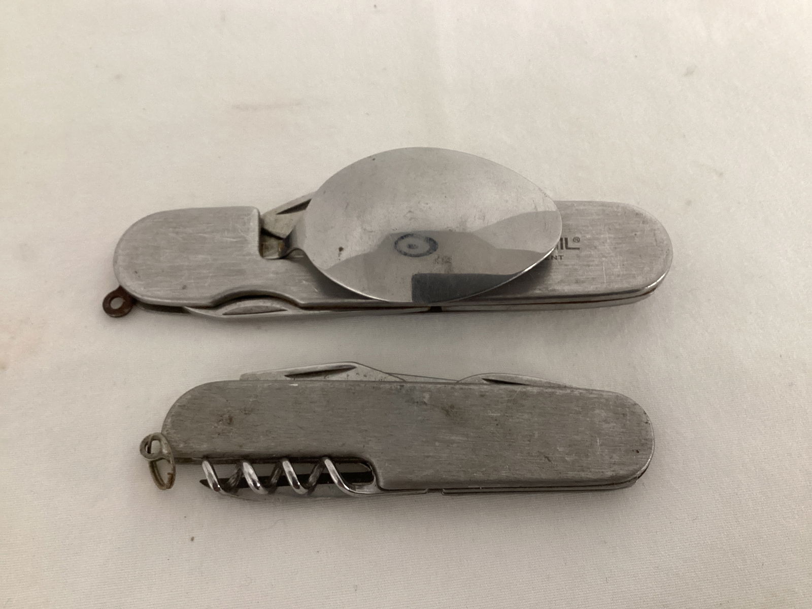 Two Outdoorsman All-in-One Pocket Knives: worn 