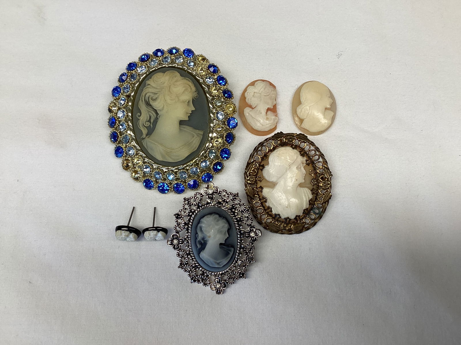 Cameo Brooches and Earrings: largest is missing stones, two are loose and one of those is missing one side 