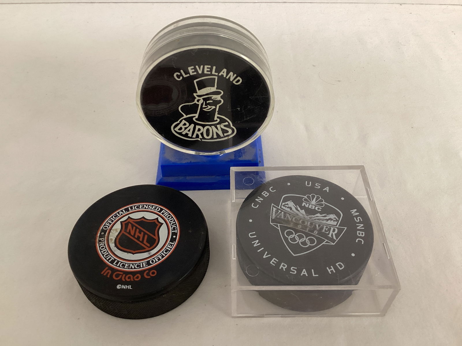 Three Hockey Pucks: one signed 