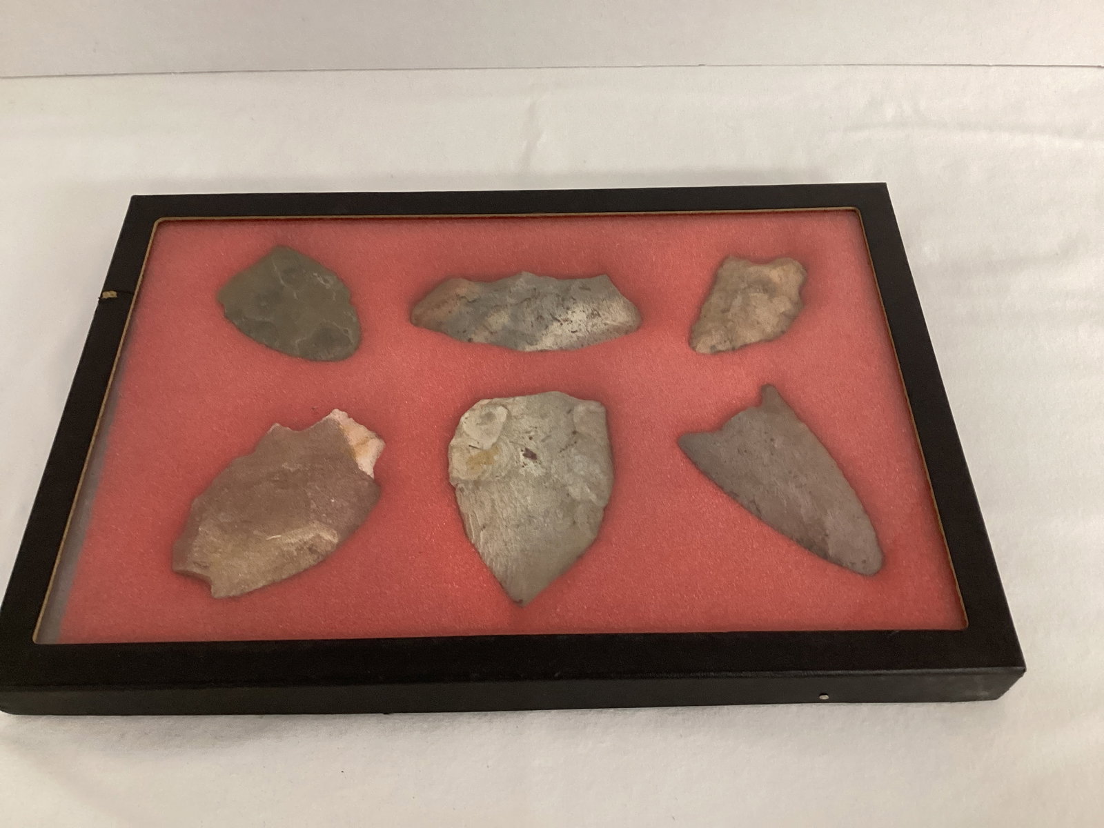 Six Carved Stone Spearheads in Display Case: found in the Dark Corners per consignor, 12 1/4" x 8 1/4" case 