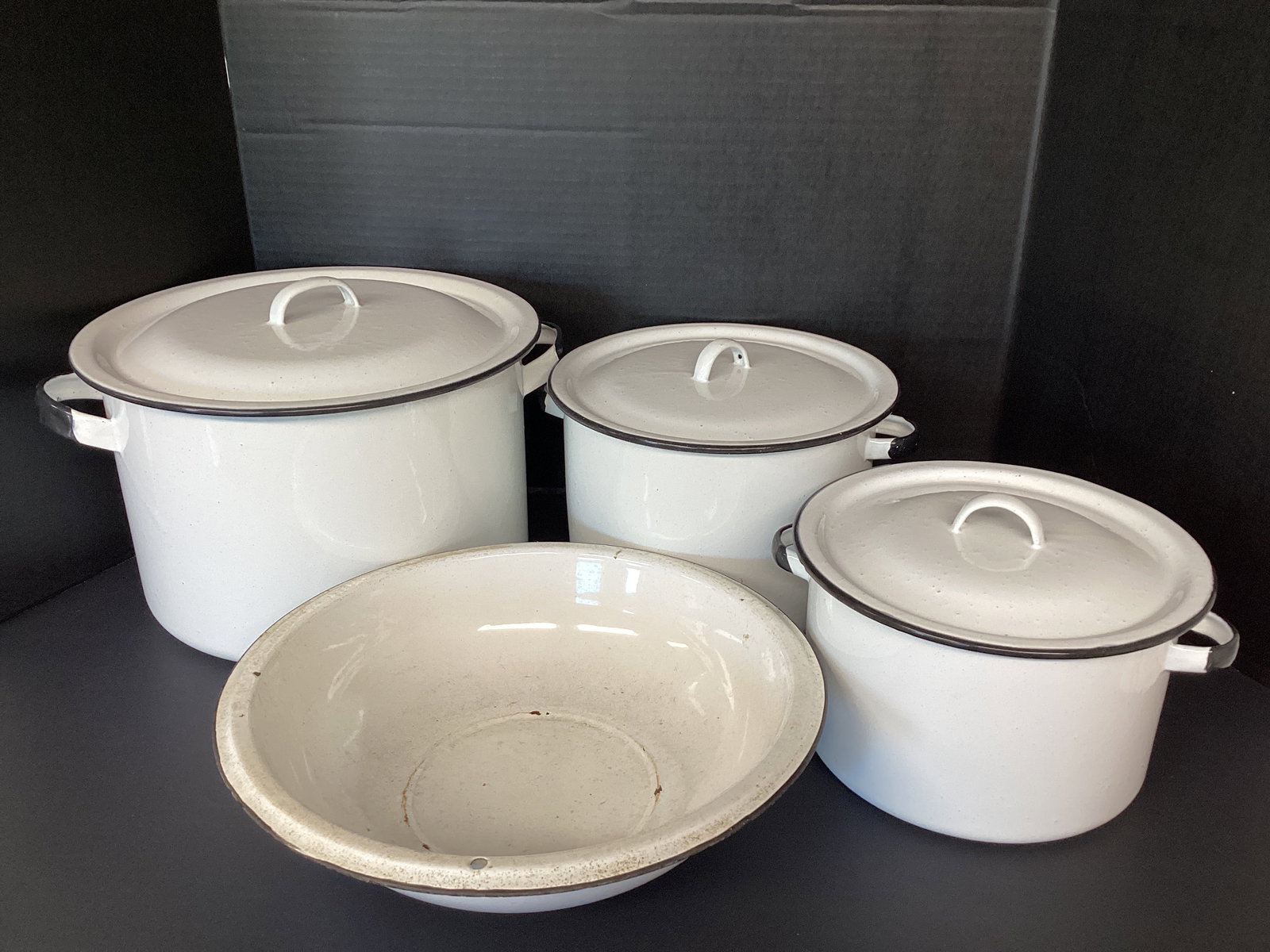 Enameled Bowl and Three Pots with Lids: Bowl is 12 3/4" diameter x 3 1/4" h with some chips. Pots are 8 1/2" diameter x 5 1/4" h, 9 1/2" diameter x 6 1/4" h, and 12" diameter x 7 3/4" h 