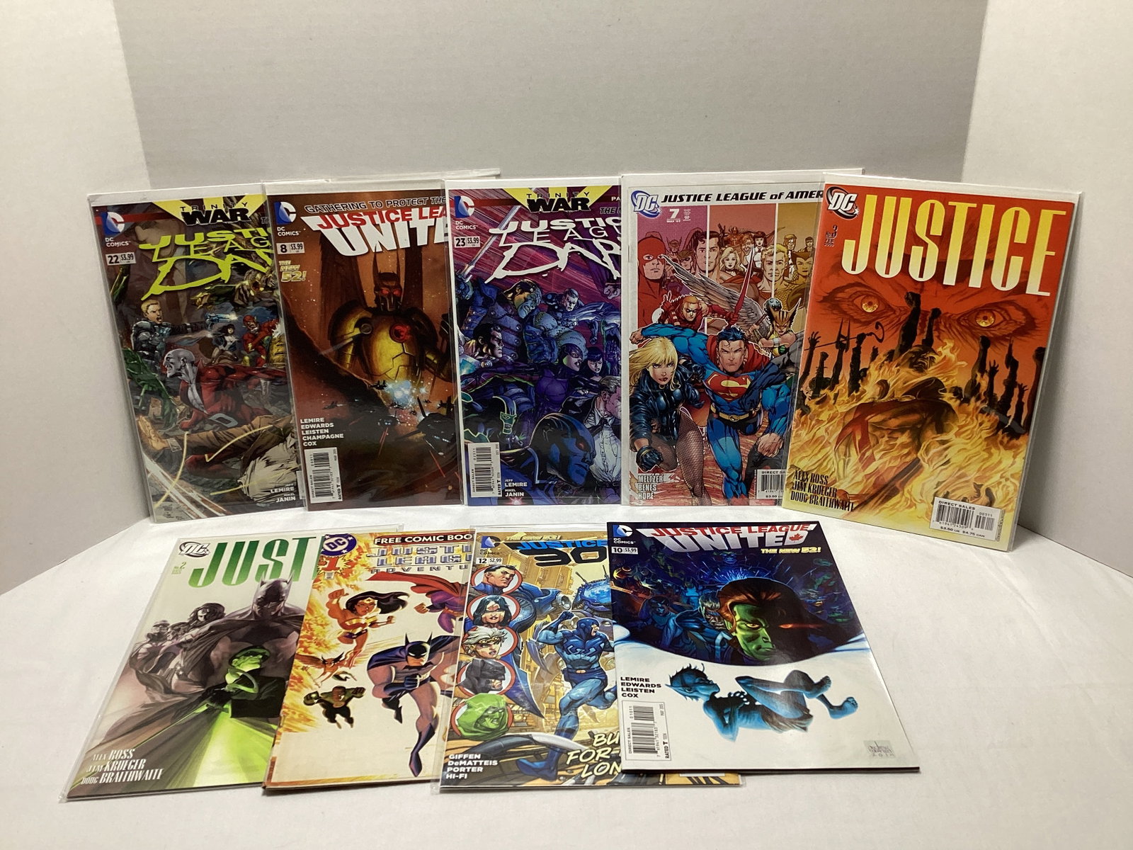 Nine Justice League DC Comic Books