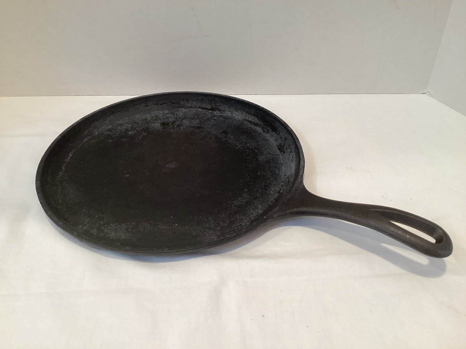 Lodge Cast Iron Griddle: 10 1/2" diameter, rust on the underside