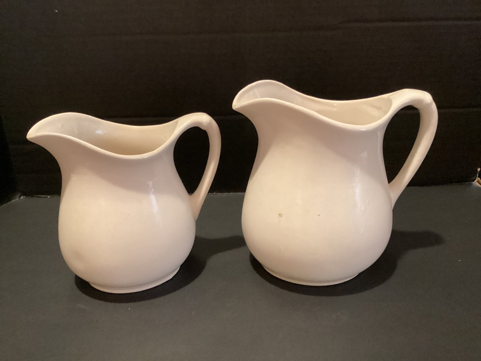 Two White Ceramic Pitchers: 6" and 7" h